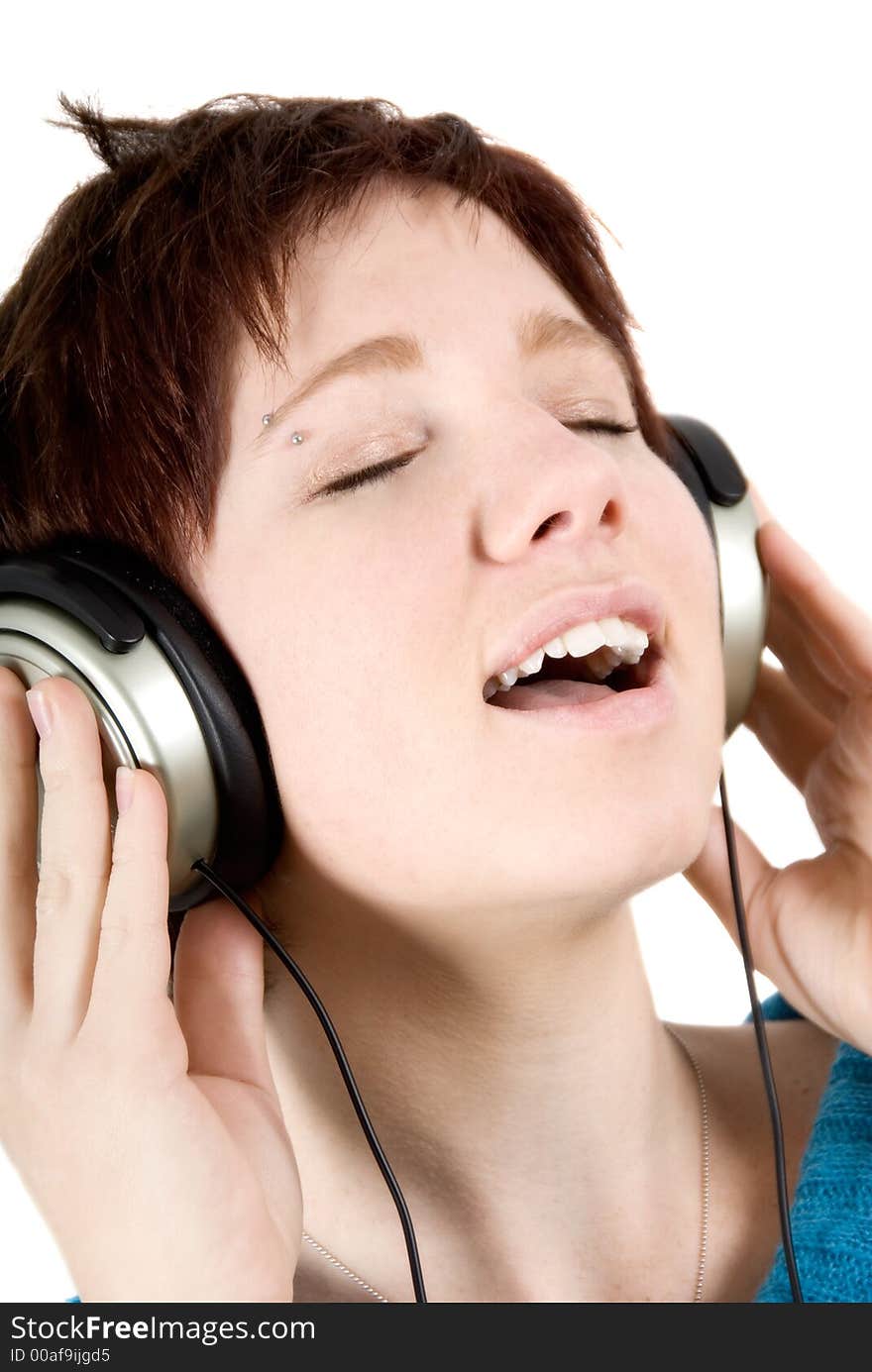 Woman holding headphones and singing. Woman holding headphones and singing