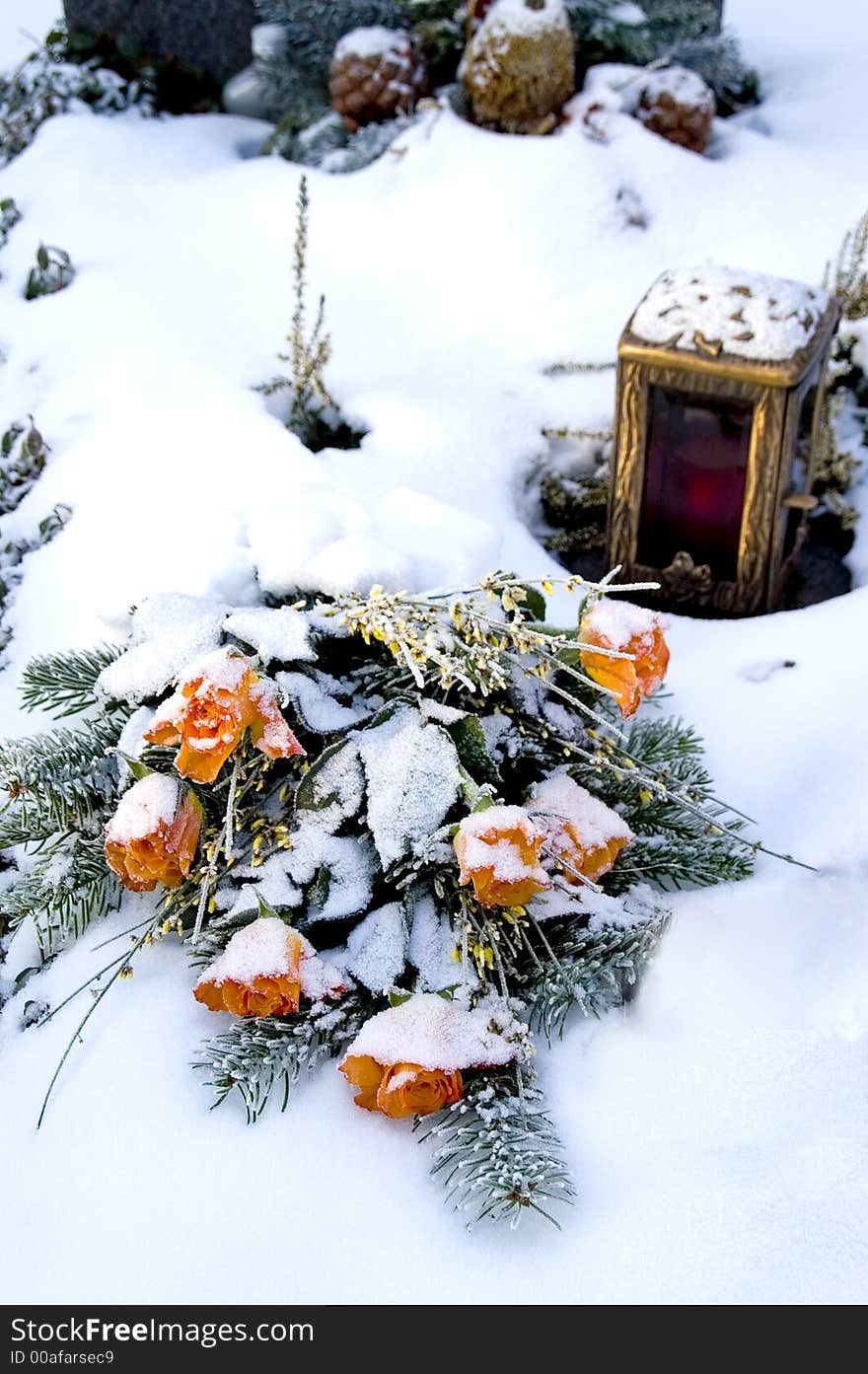 Orange rose bouquet on a snowy grave. Orange rose bouquet on a snowy grave.