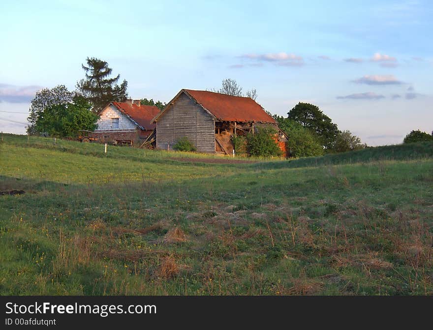 Evening spring landscape with old farm