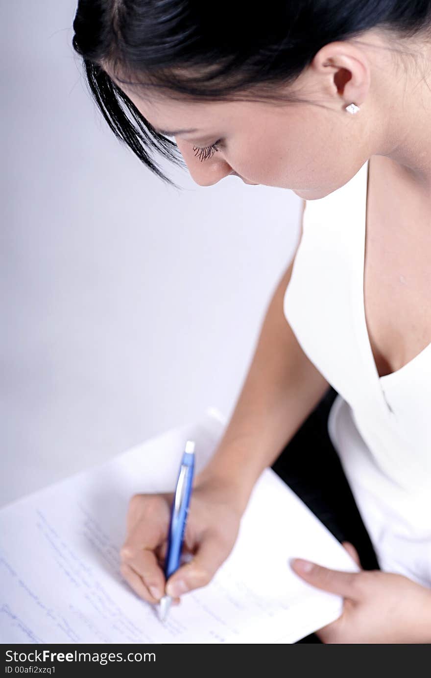 Picture of woman handwriting notes with blue pen. Picture of woman handwriting notes with blue pen.