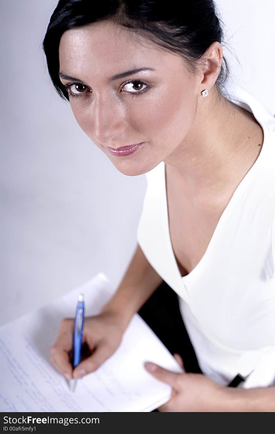 Picture of woman handwriting notes with blue pen. Picture of woman handwriting notes with blue pen.