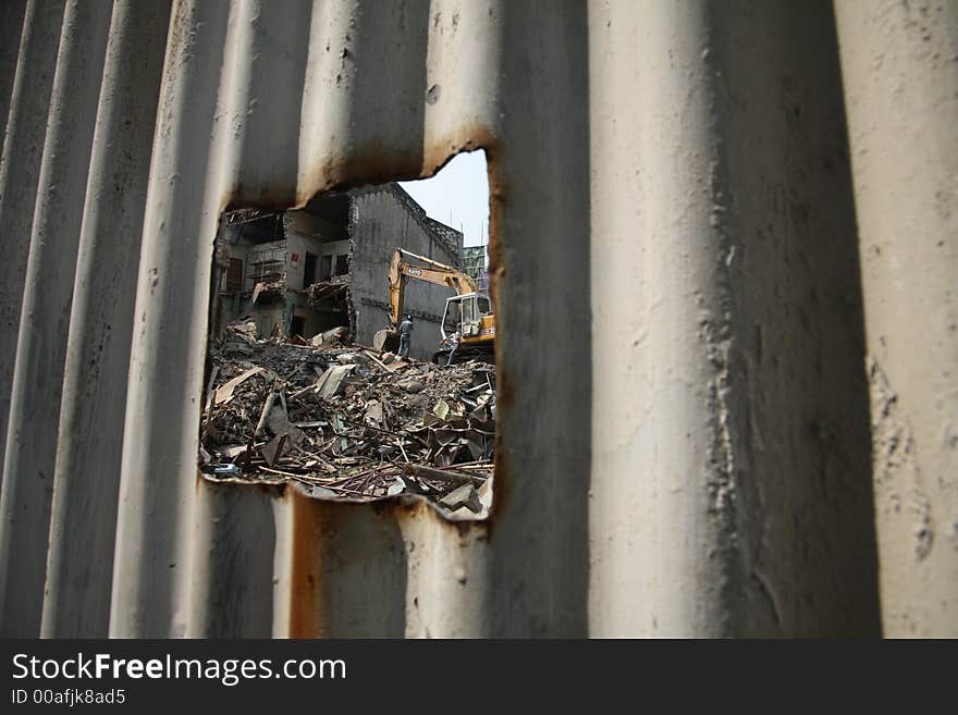 Hole in wall looking into construction site