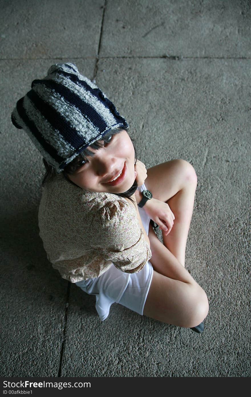 Girl sitting on floor looking at viewer smiling