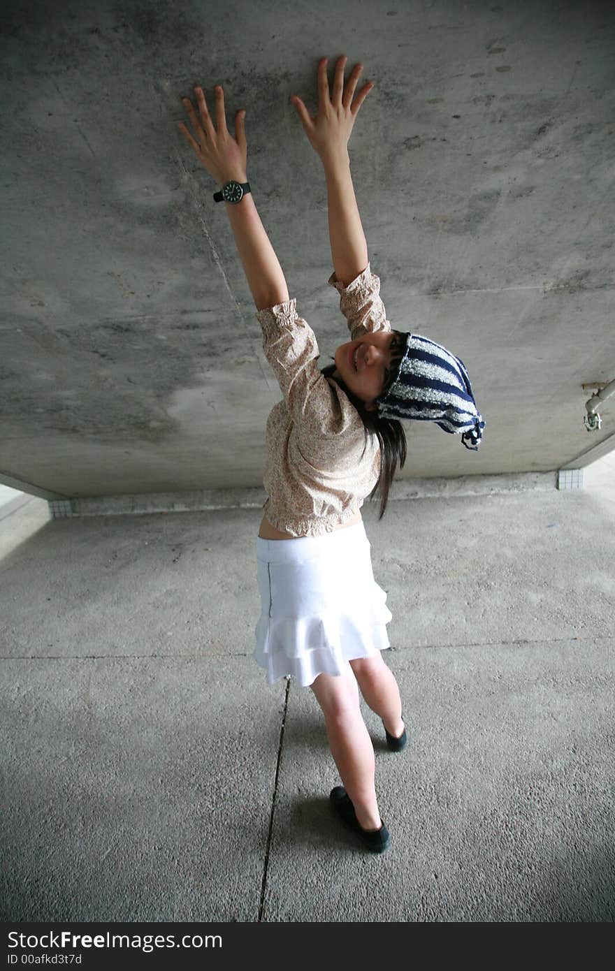 Girl with hands on wall