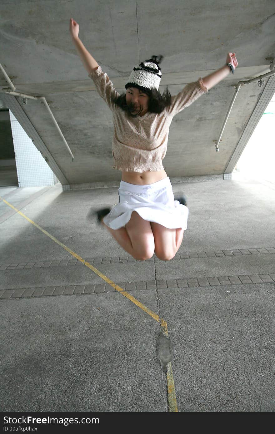 Girl jumping with legs up