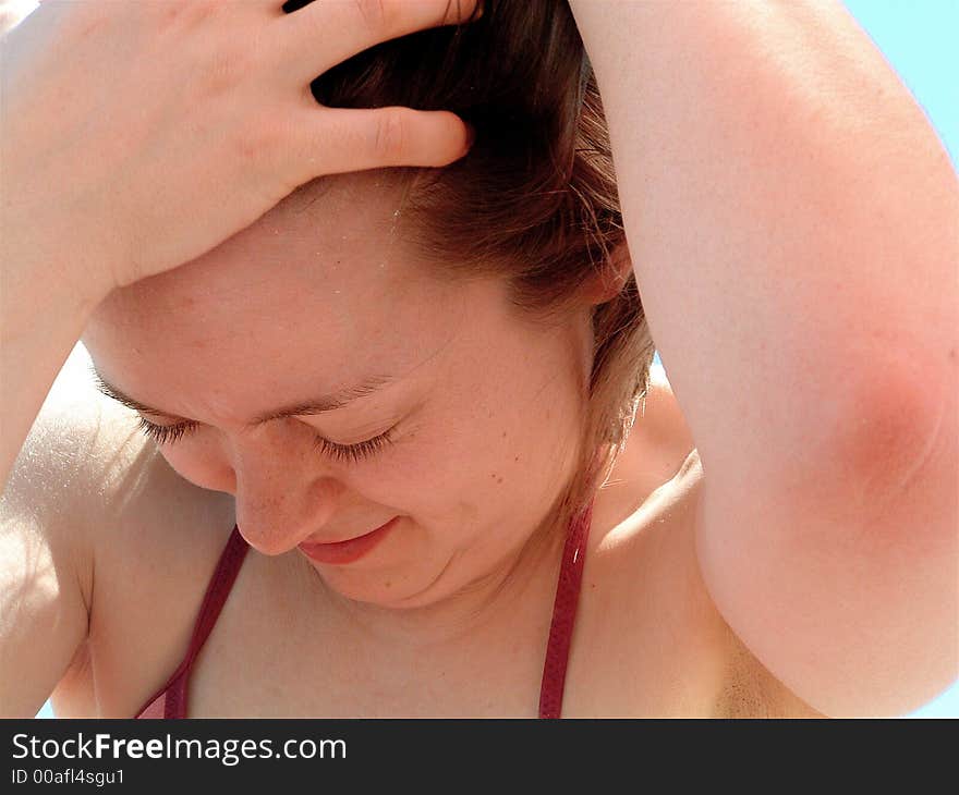 Closeup of Woman Pulling Hair Away From Face