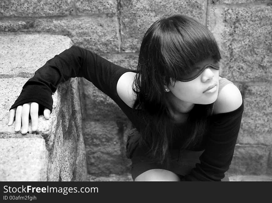 Asian girl wearing a blindfold covering her eyes. Asian girl wearing a blindfold covering her eyes