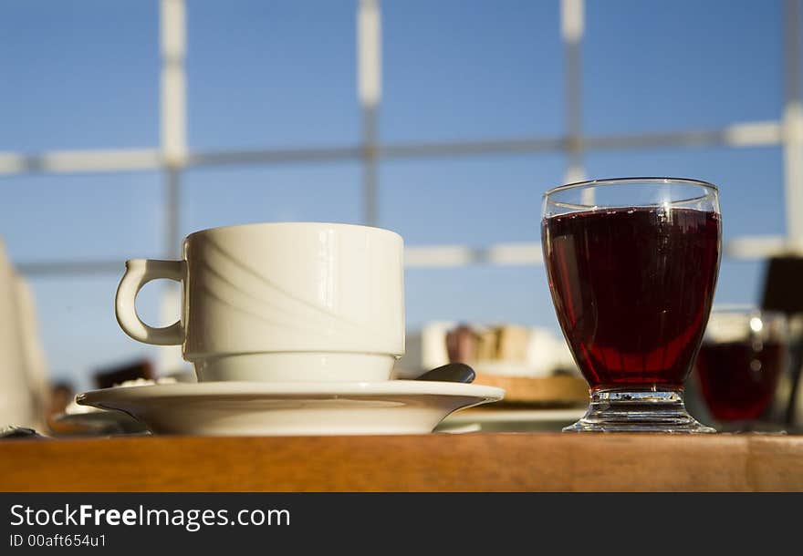 A cup and a glass on a background of the light-blue sky