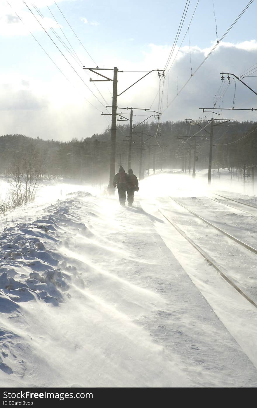 View of two men walking in snow. View of two men walking in snow.