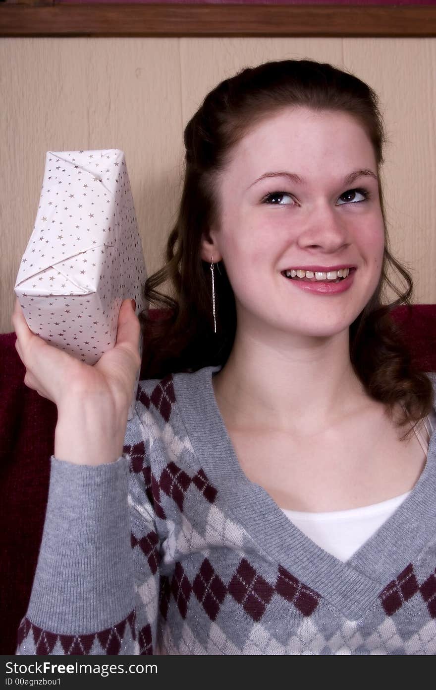 Attractive teen trying to guess what her birthday present is.