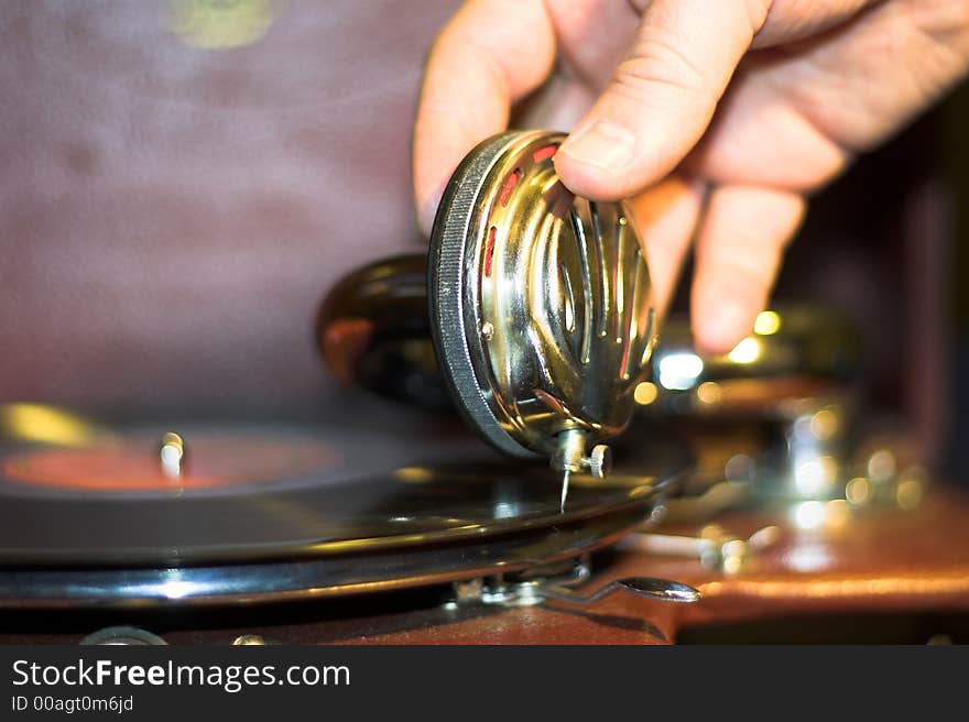 Old gramophone and human hand starting music. Old gramophone and human hand starting music