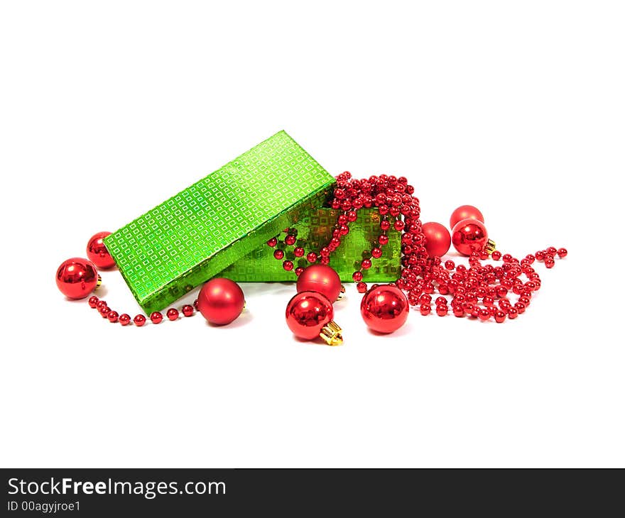 Red Christmas balls in green box on white background