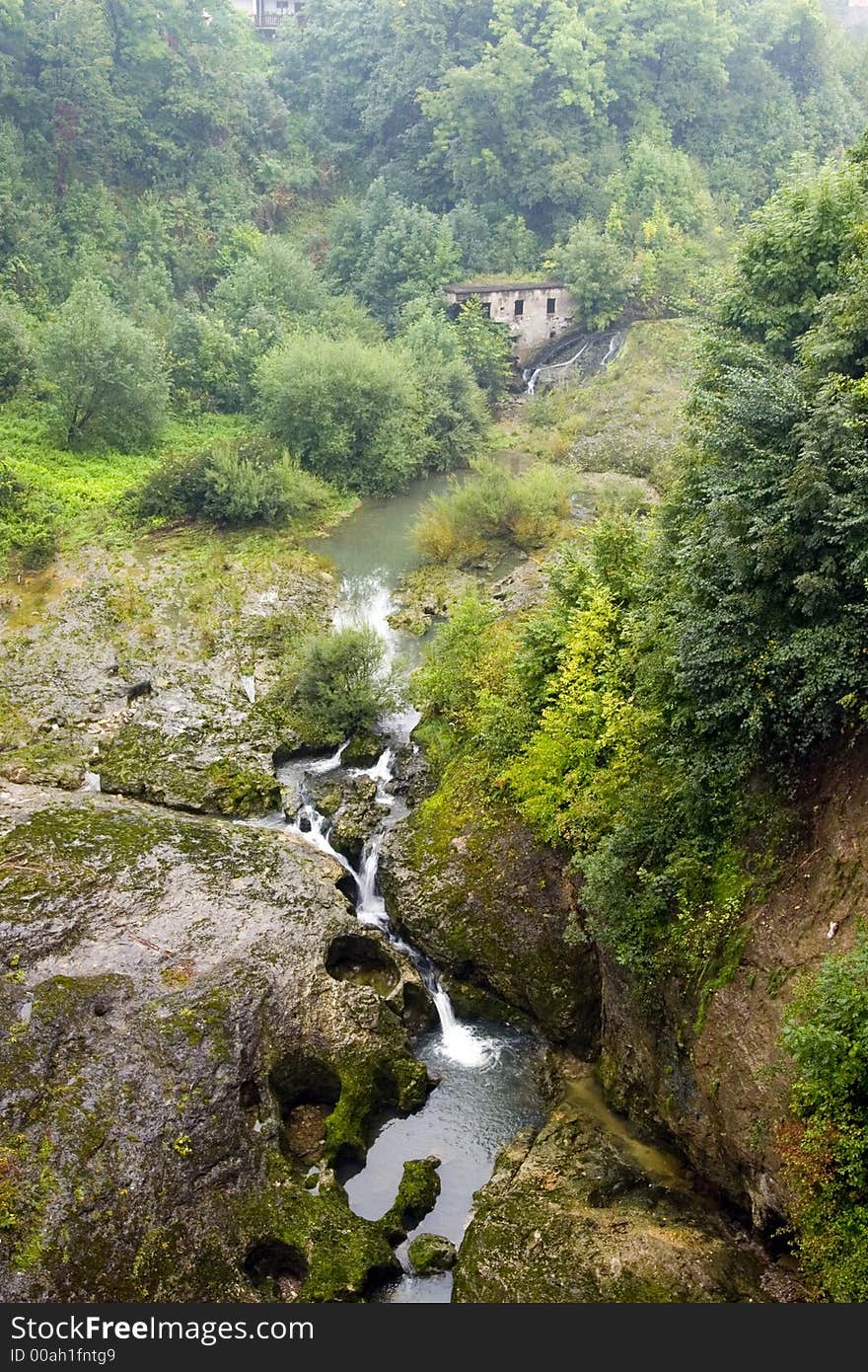 Waterfall in nature with old house