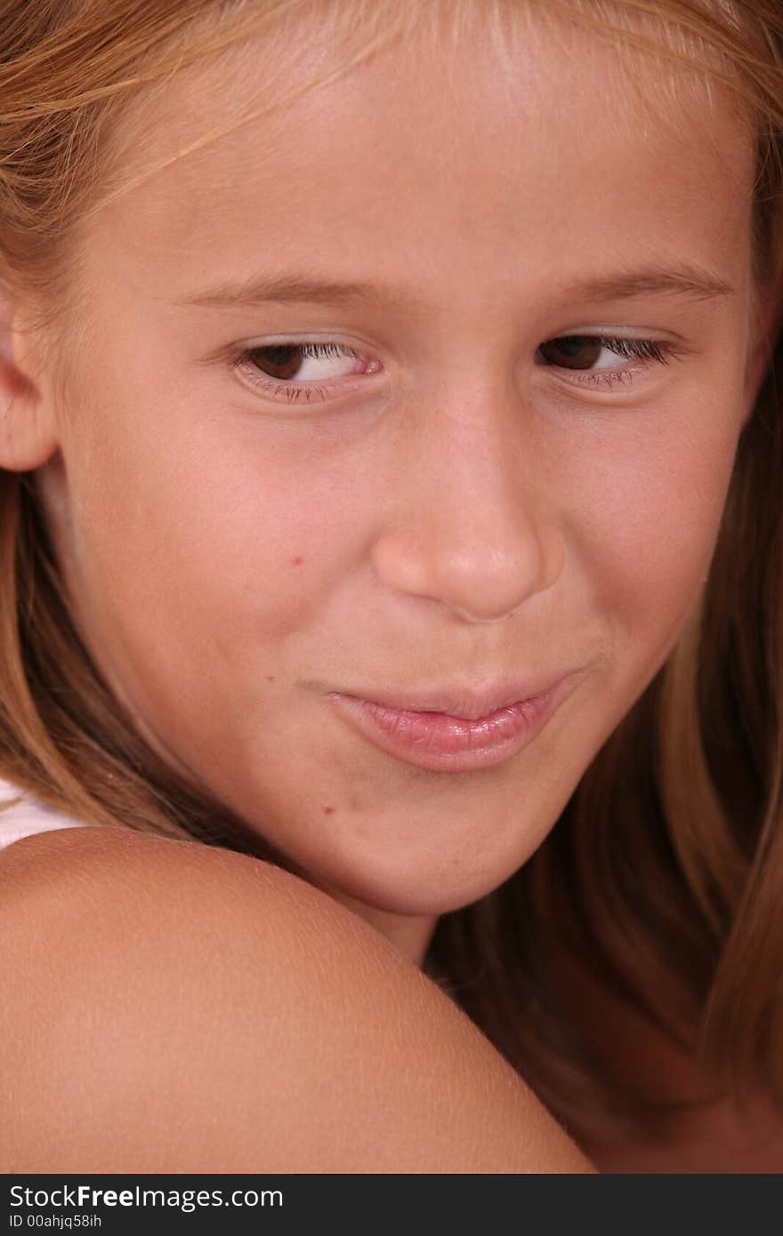 A young girl tries to smile