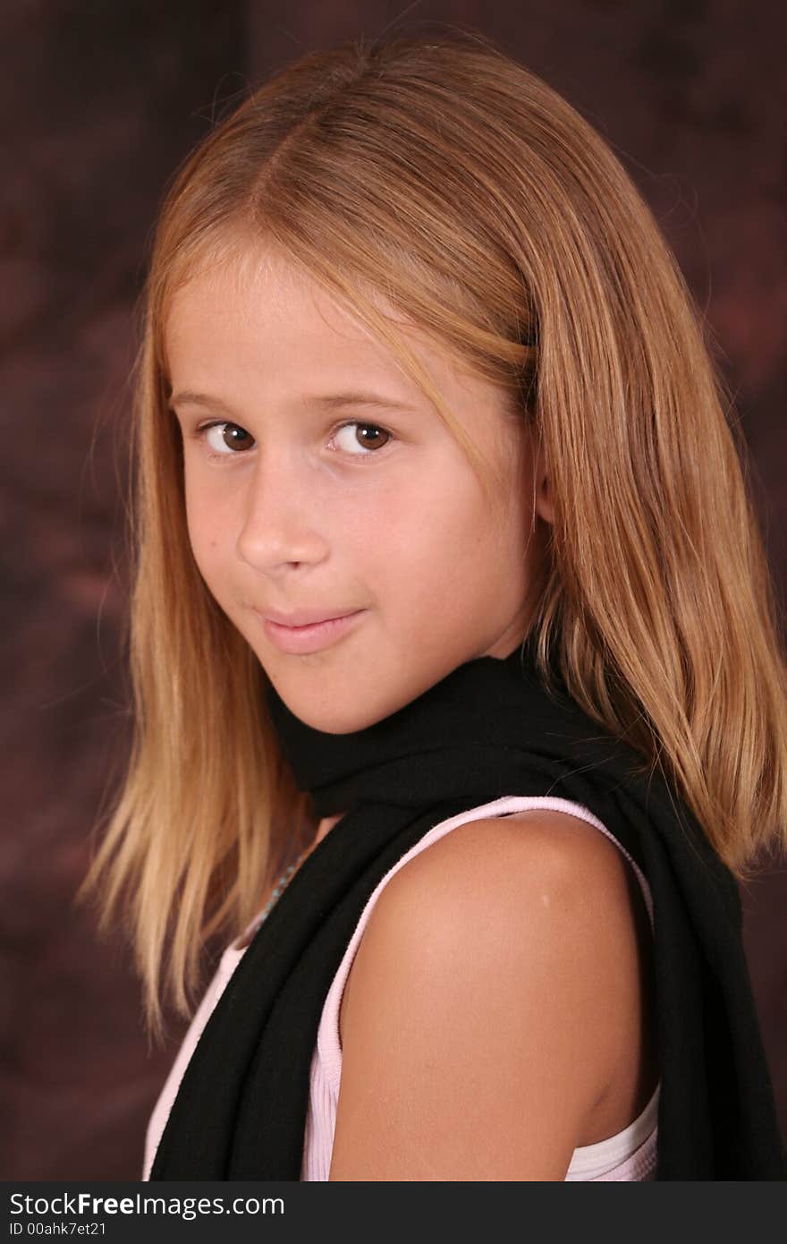 Young girl poses for photo wearing scarf. Young girl poses for photo wearing scarf