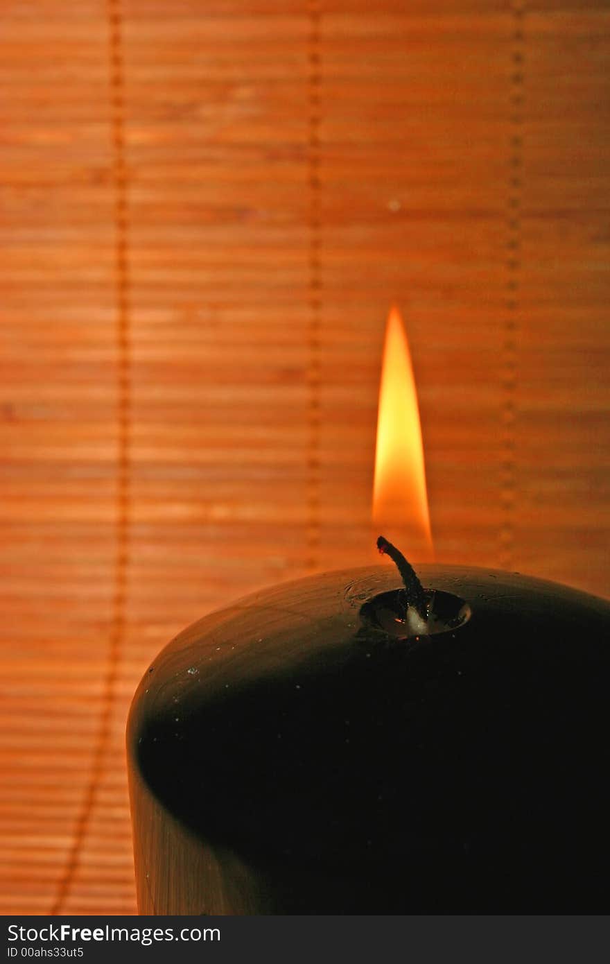 A candlelight on a bamboo background