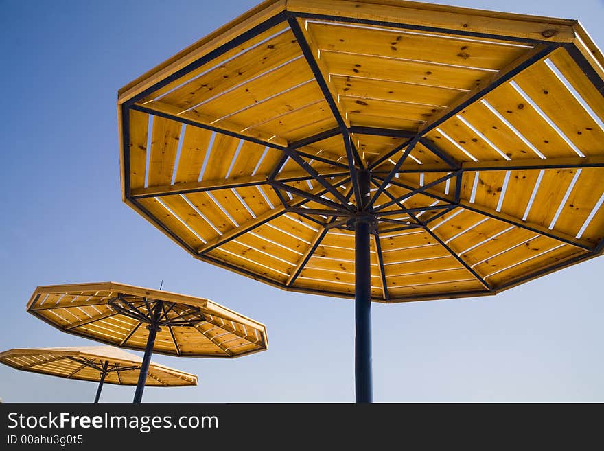 Parasols on a blue summer sky.