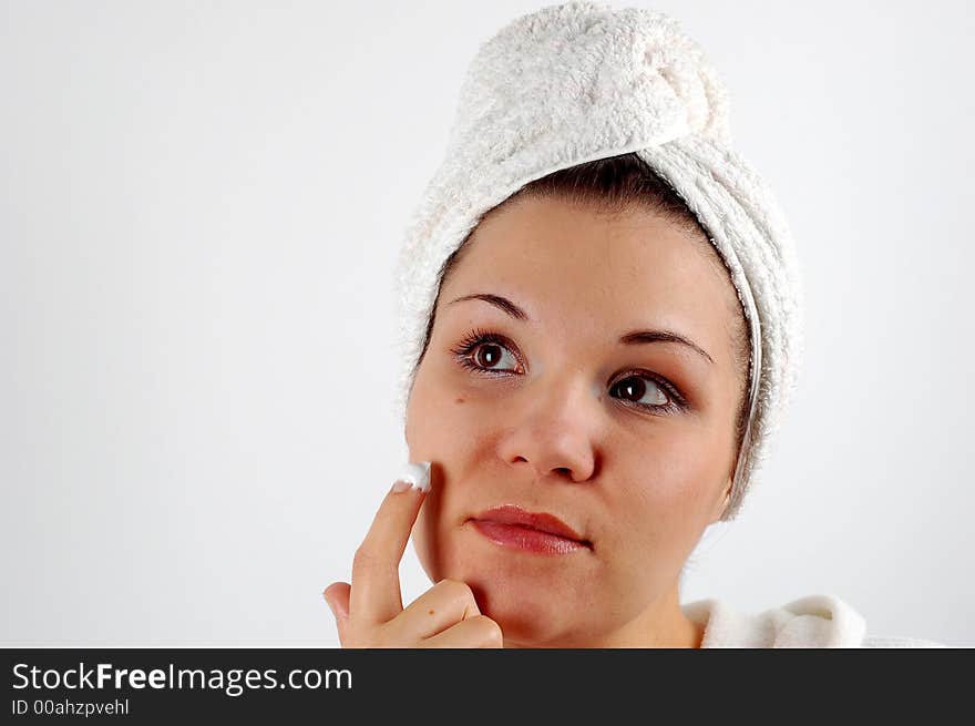 Attractive woman with cream on white background. Attractive woman with cream on white background