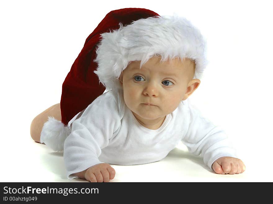 A baby wearing a Santa hat on a white background. A baby wearing a Santa hat on a white background