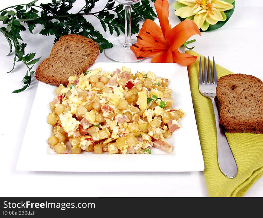 A plate of creamy scrambled eggs with toast bread