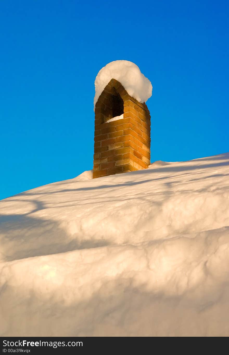 Chimney that is covered in snow. Chimney that is covered in snow