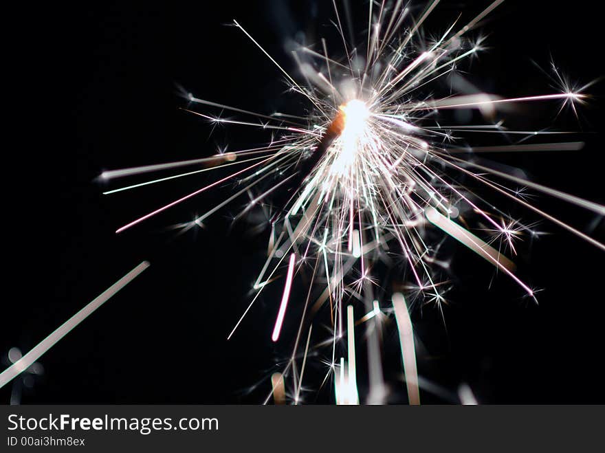 Bruning sparkler with stars at night