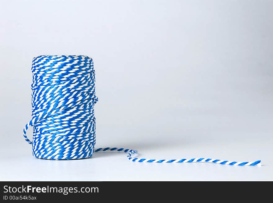 Winded blue and white cord isolated on white background