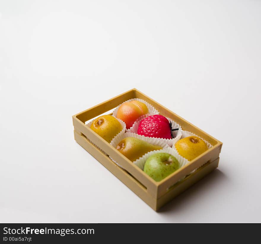 Crate with sweet candies shaped as fruit. Crate with sweet candies shaped as fruit.