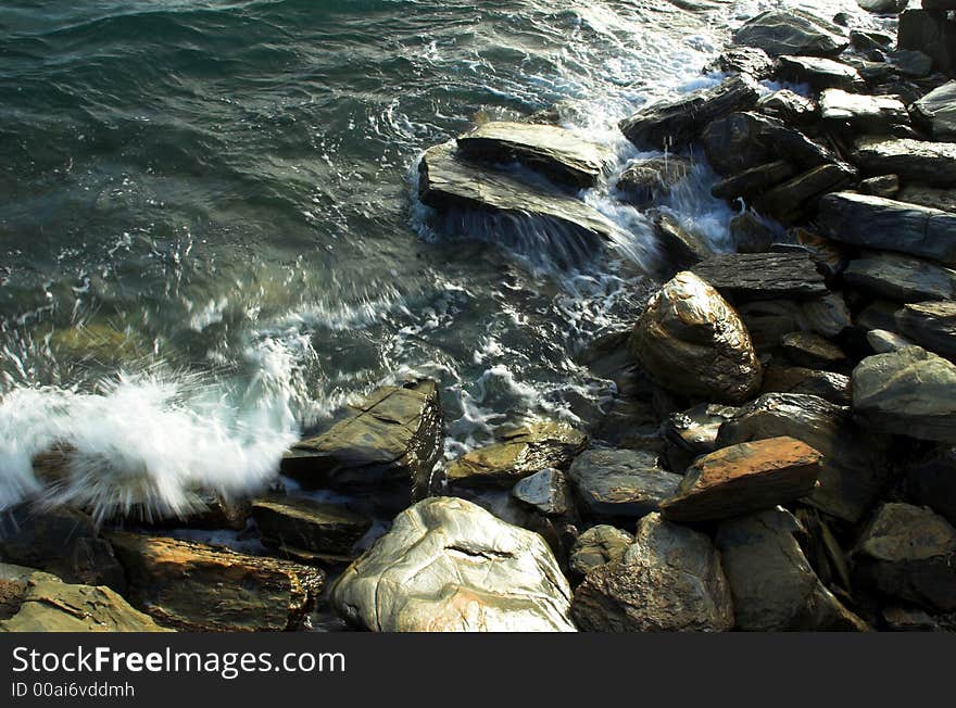 Rocky shoreline with waves from the ocean crashing over them. Rocky shoreline with waves from the ocean crashing over them