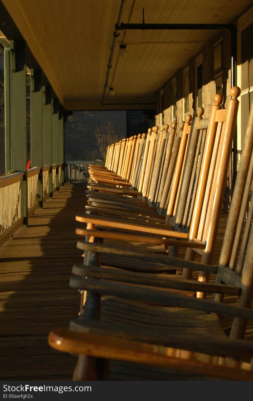 Row of rocking chairs on the porch of an inn. Row of rocking chairs on the porch of an inn