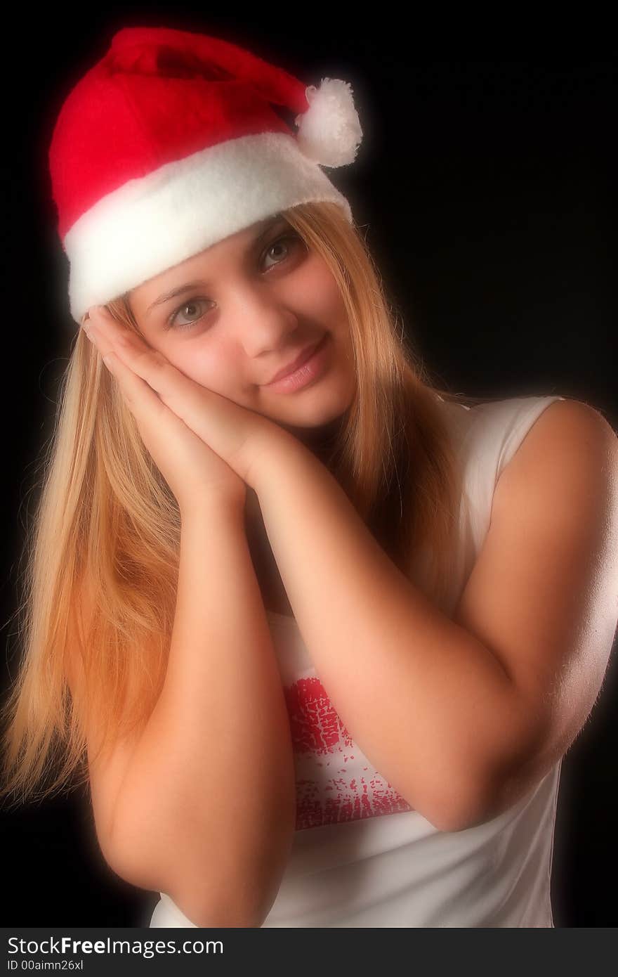 Gesticulated Christmas blonde girl like reposing, black background. Gesticulated Christmas blonde girl like reposing, black background