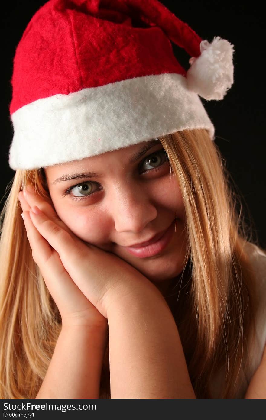 Gesticulated Christmas blonde girl like reposing, black background. Gesticulated Christmas blonde girl like reposing, black background