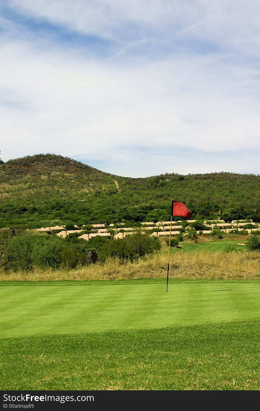 Red flag on the green. Sunny windy day. Red flag on the green. Sunny windy day.