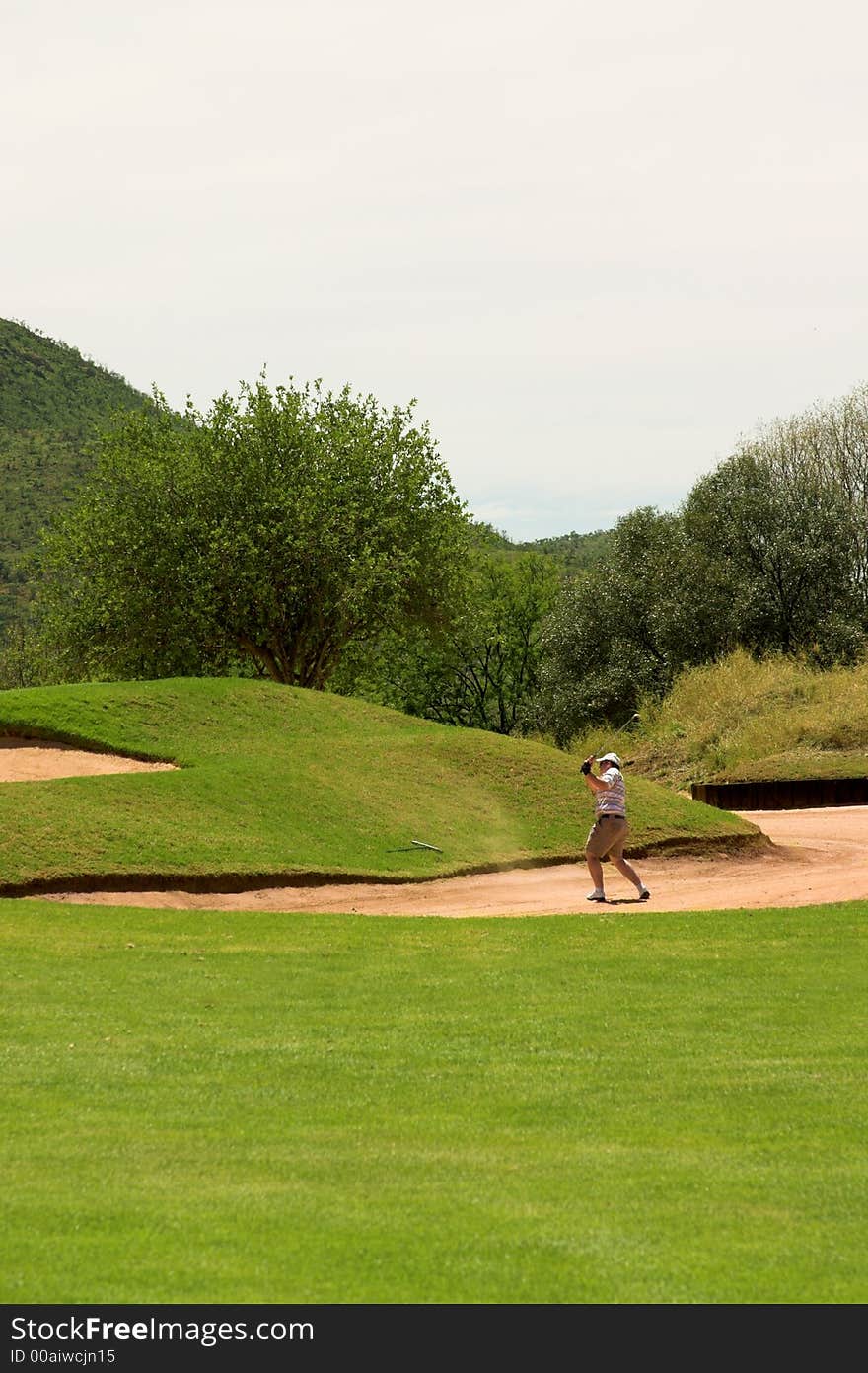 Golfer in the sand bunker