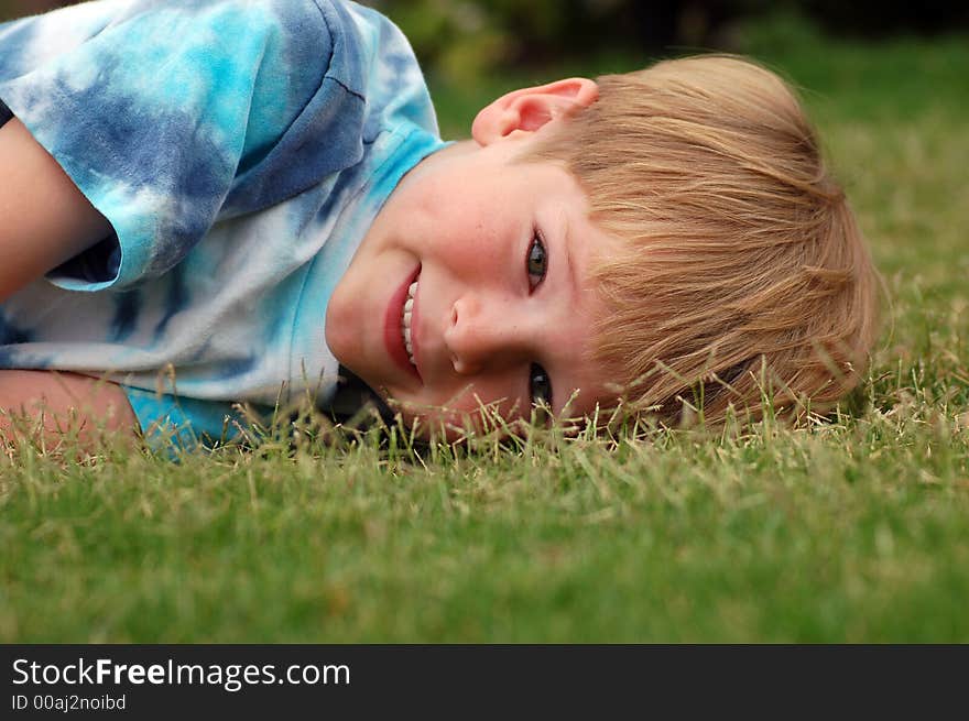 Boy Lying In Grass