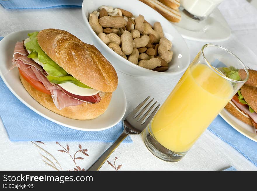 Breakfast with sandwich and orange juice close up