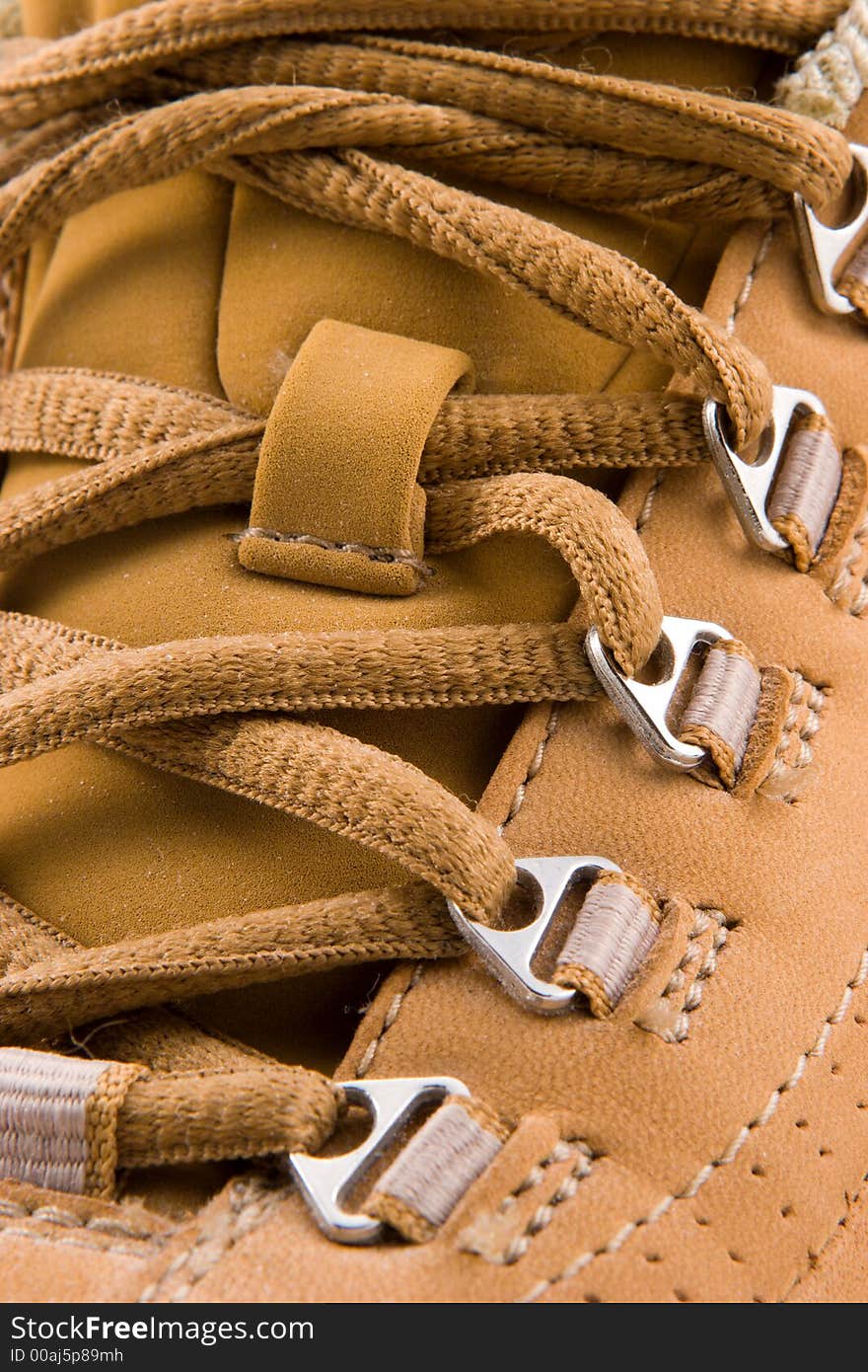 Close up view of a soft leather walking shoe, showing laces in detail.