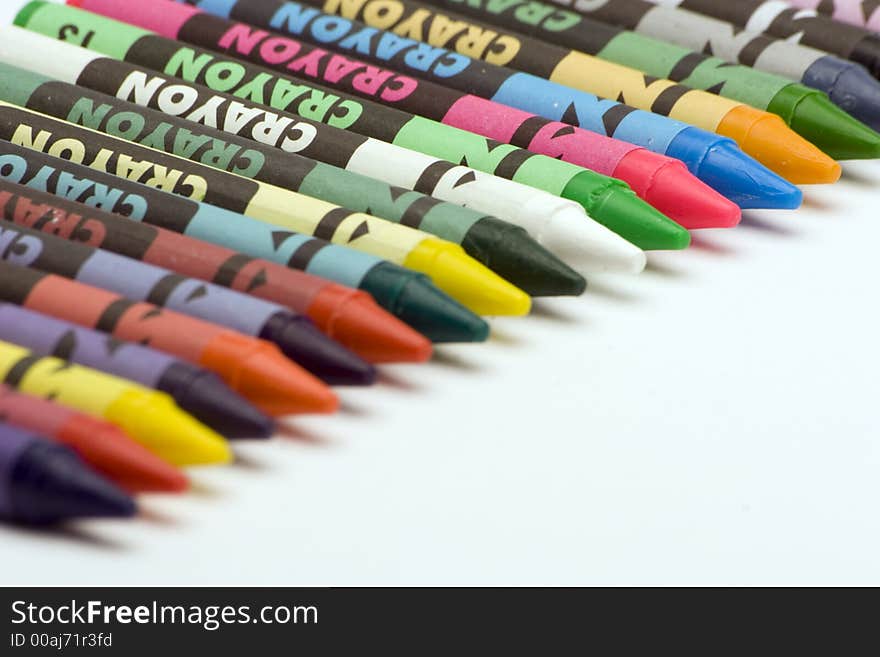 Multi Coloured Crayons set against a plain backgrund.