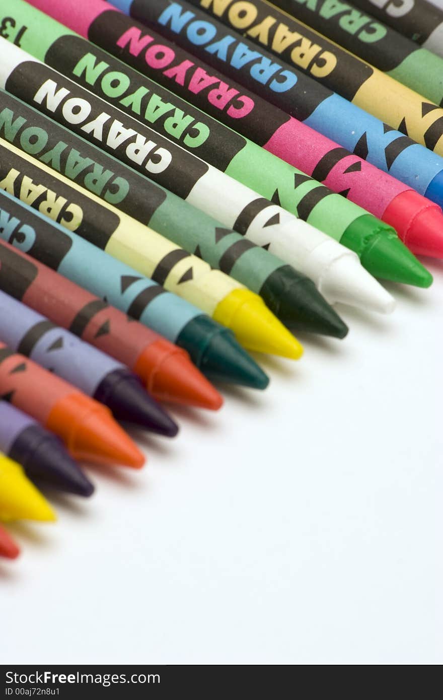 Multi Coloured Crayons set against a plain backgrund.