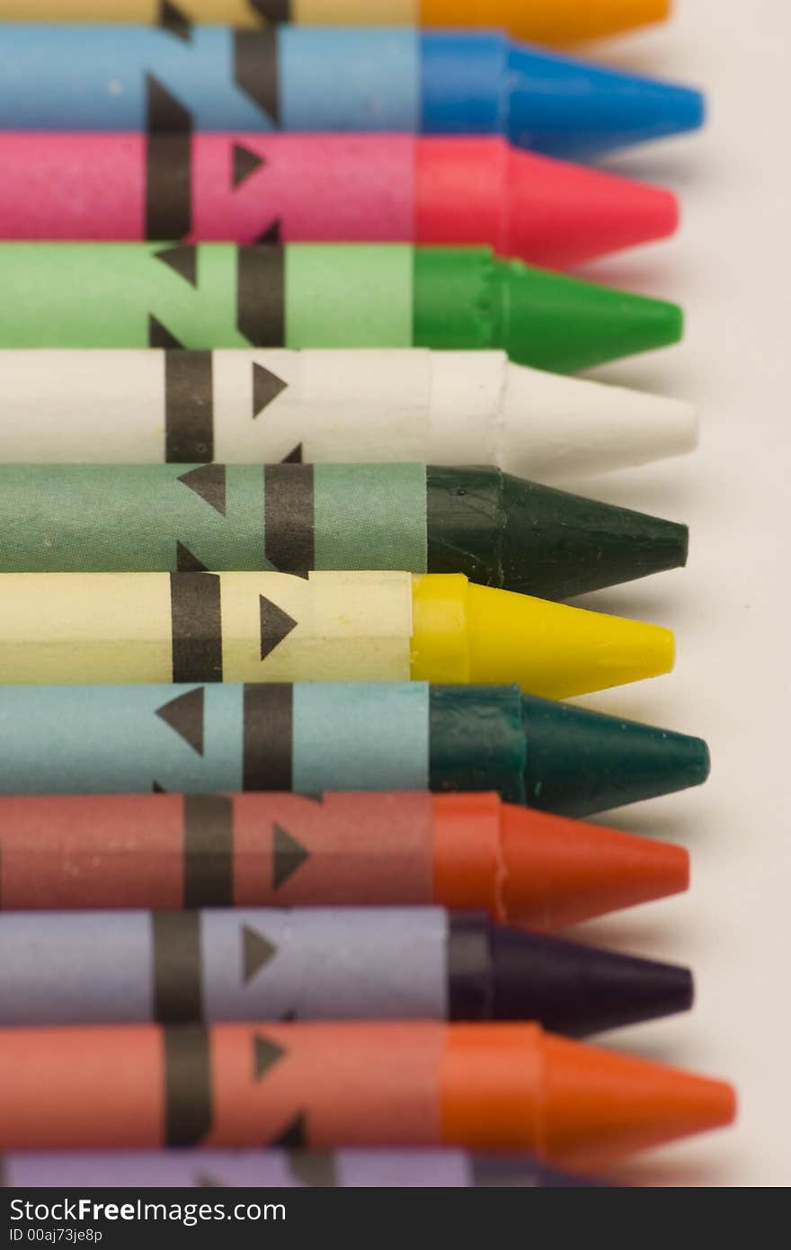 Multi Coloured Crayons set against a plain backgrund.