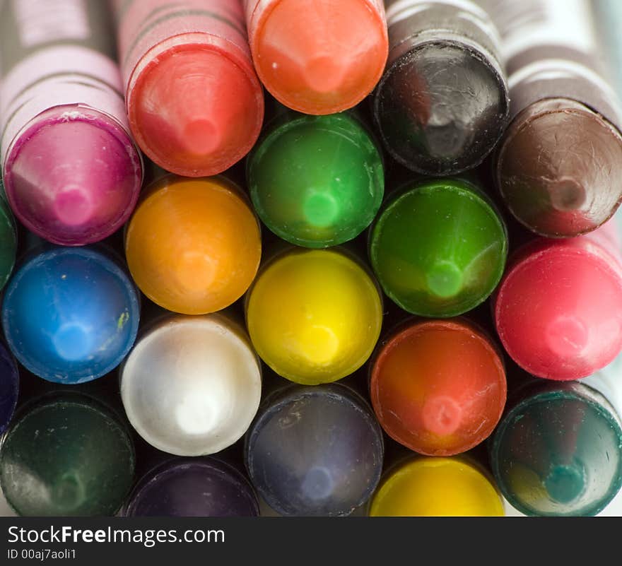 Multi Coloured Crayons set against a plain backgrund.