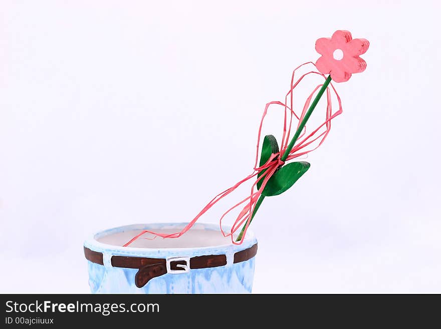 Wooden flower in flowerpot isolated on background