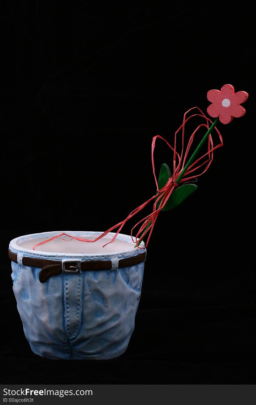 Wooden flower in flowerpot isolated on black background