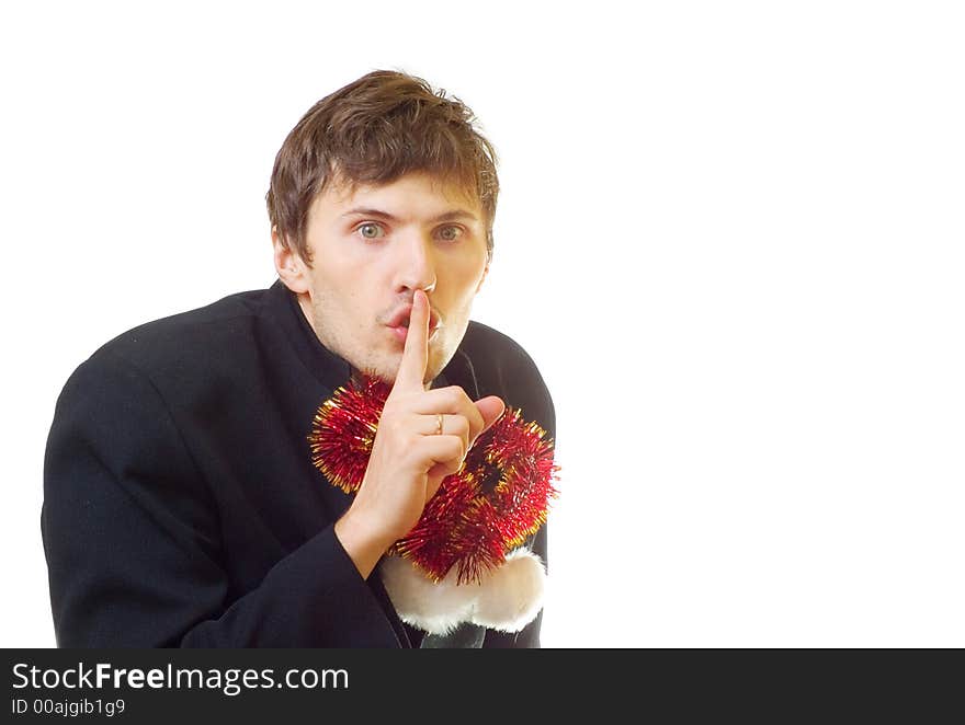 A man dressed in suit with xmas hat and tinsel in one's bosom ask you to be quiet; over white background. A man dressed in suit with xmas hat and tinsel in one's bosom ask you to be quiet; over white background