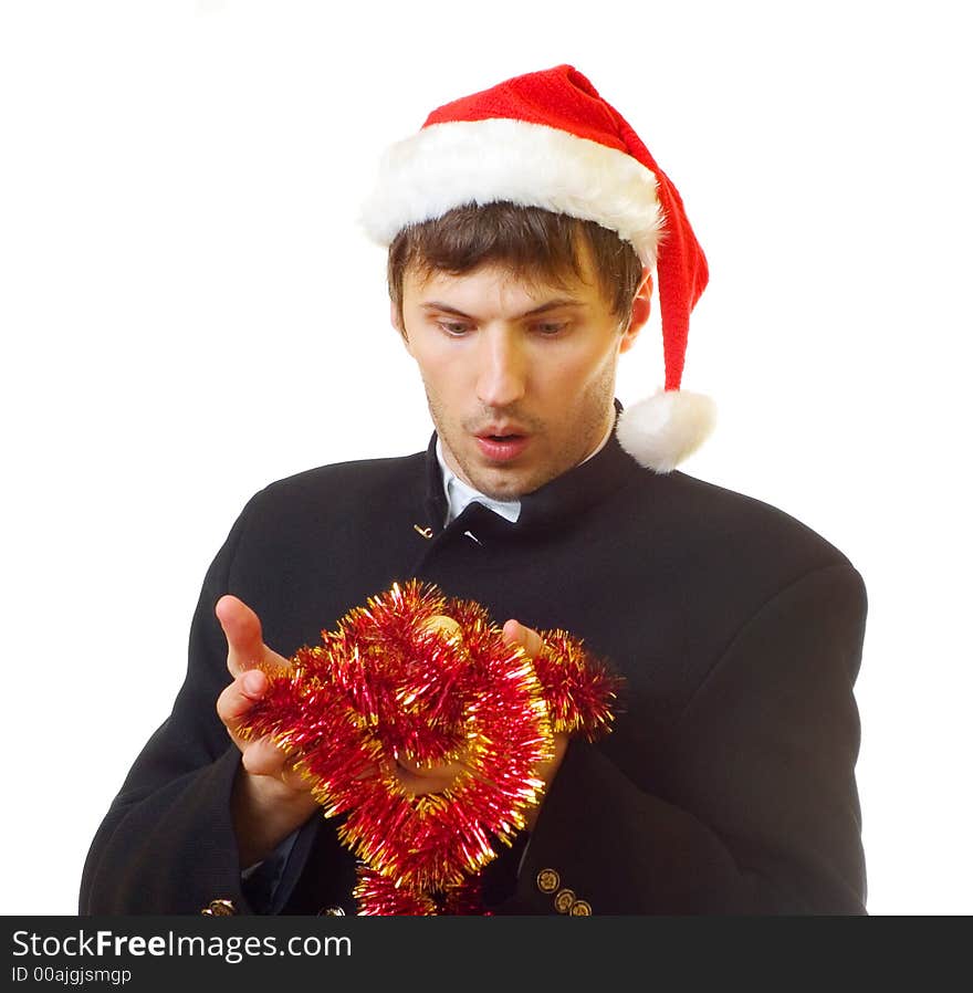 A man dressed in suit, xmas hat with tinsel and bells is very surprised; over white background. A man dressed in suit, xmas hat with tinsel and bells is very surprised; over white background