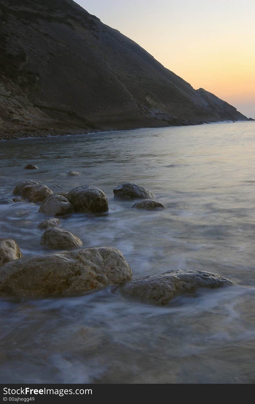 Long exposure at sunset at the sea with rocks, splashing water. Long exposure at sunset at the sea with rocks, splashing water