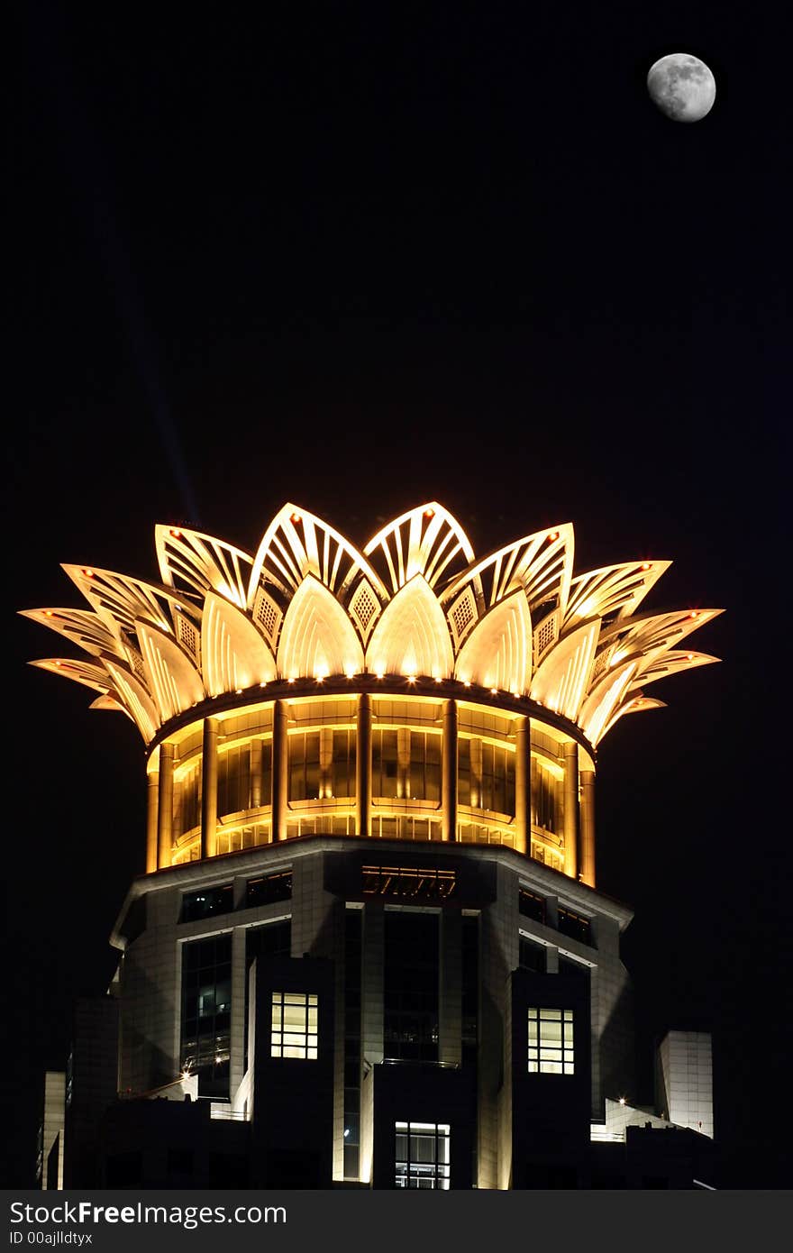 Top of a modern building likes a beautiful flower in the evening sky. Top of a modern building likes a beautiful flower in the evening sky.