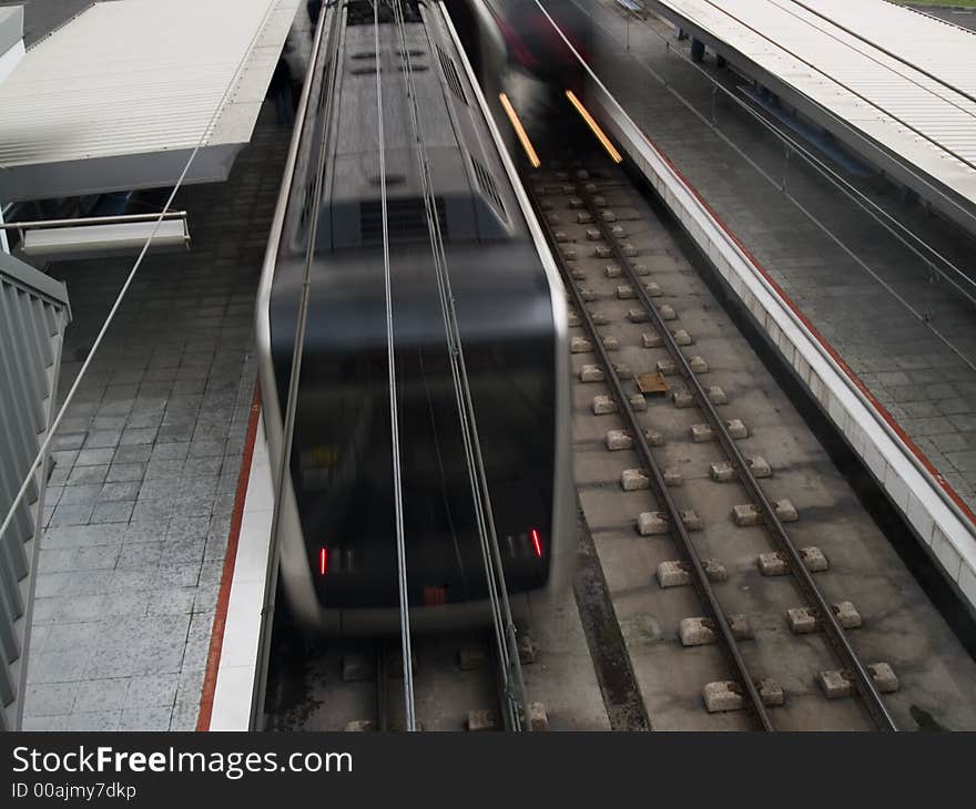 Nearly empty urban metro station with departing trains