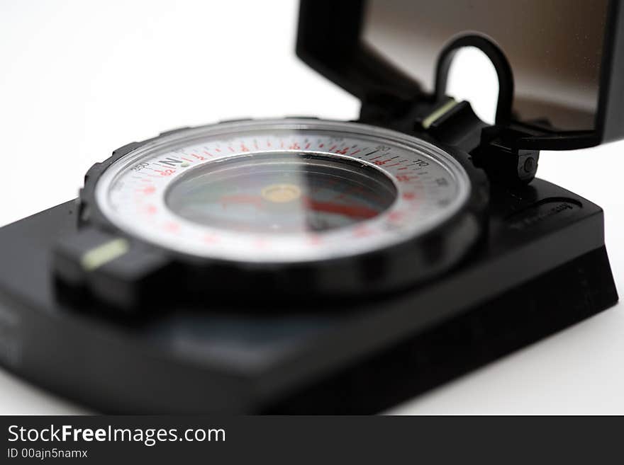 A compass and a white background