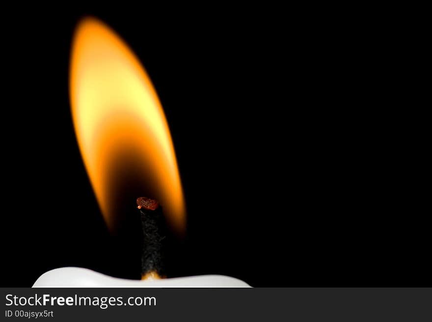 Horizontal flame close up of the flame of a white candle